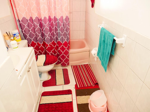 full bathroom with vanity, toilet, tile walls, and shower / bath combo with shower curtain