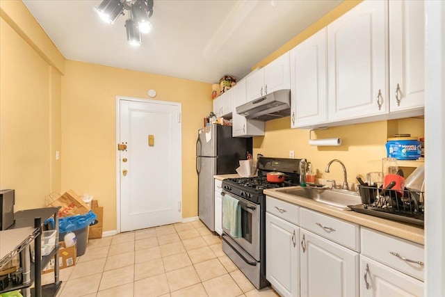 kitchen with white cabinetry, light tile patterned flooring, and stainless steel appliances