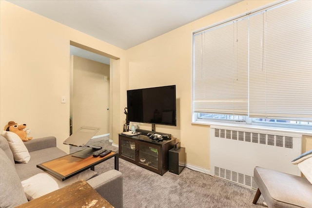 living room with light carpet and radiator