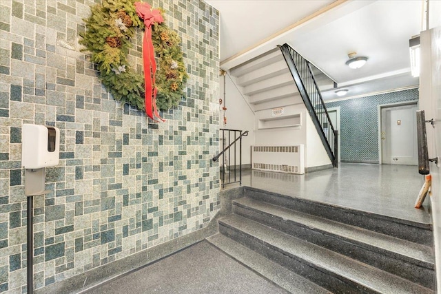 staircase with radiator and tile walls