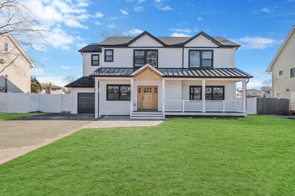 modern farmhouse featuring a front yard and a porch