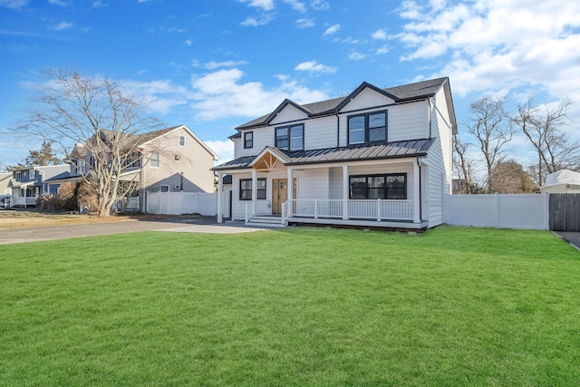 view of front of home with covered porch and a front yard