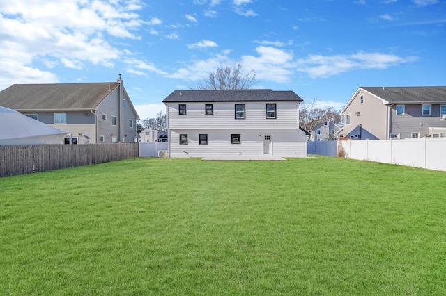 back of house featuring a yard