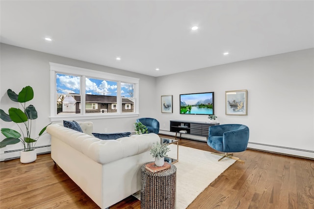 living room featuring light wood-type flooring and a baseboard radiator