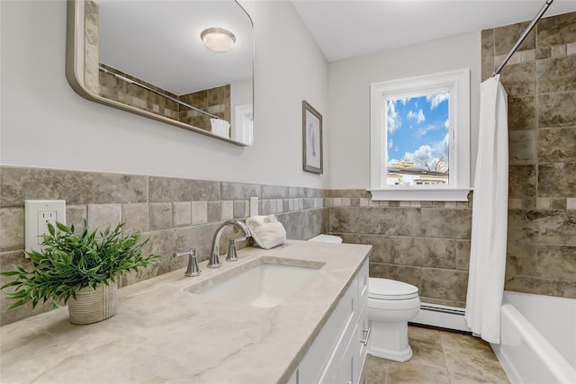 full bathroom with vanity, tile patterned floors, toilet, baseboard heating, and tile walls