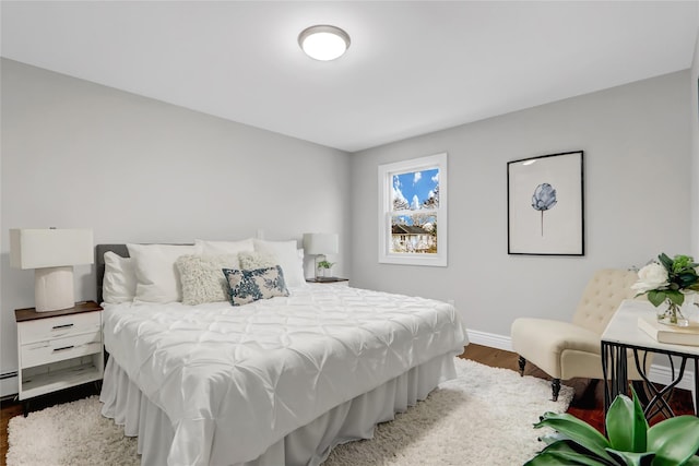 bedroom featuring hardwood / wood-style flooring and a baseboard radiator