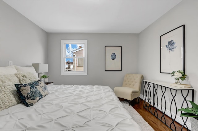 bedroom with dark hardwood / wood-style flooring