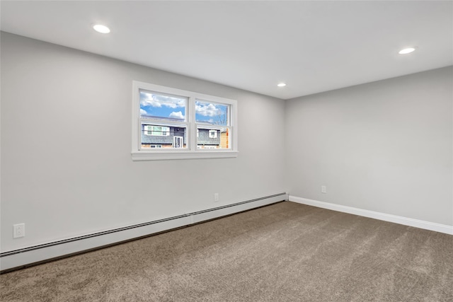 carpeted empty room featuring a baseboard heating unit