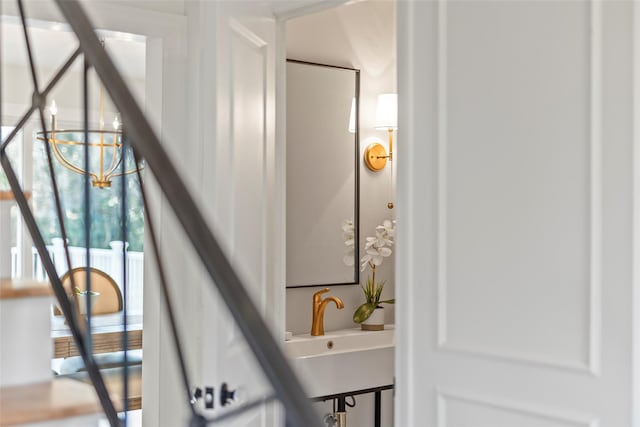 bathroom with a notable chandelier and sink