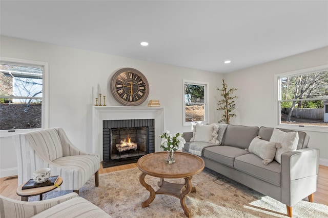 living room with a fireplace and light hardwood / wood-style floors