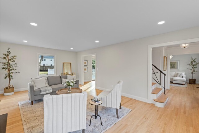 living room featuring plenty of natural light and light hardwood / wood-style flooring