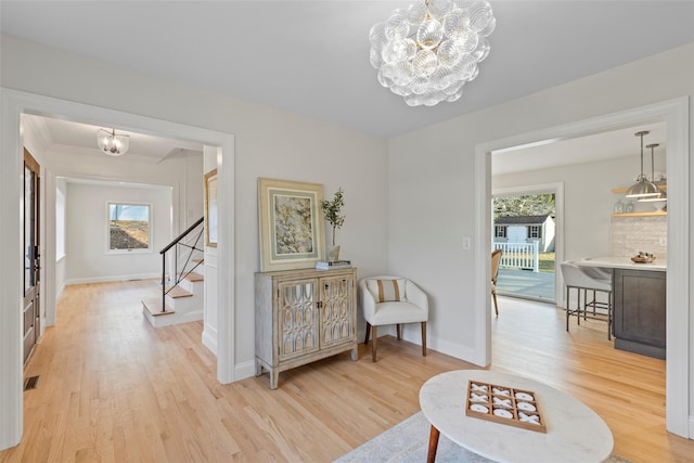 sitting room featuring light hardwood / wood-style flooring and a notable chandelier