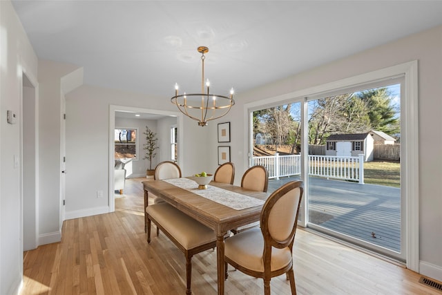 dining room featuring a chandelier and light hardwood / wood-style floors