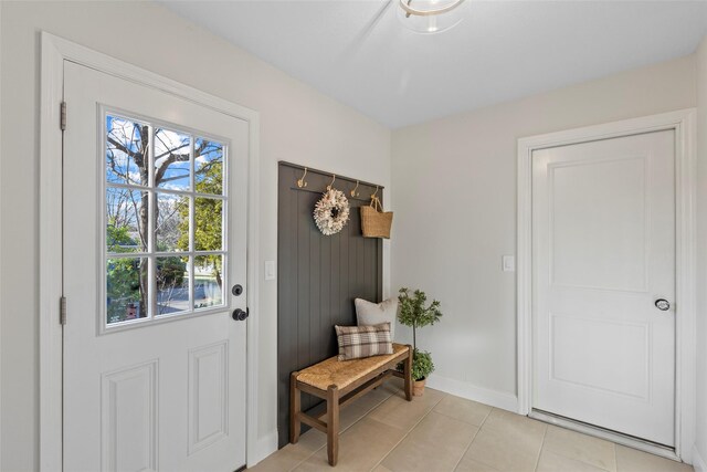 doorway to outside with light tile patterned floors