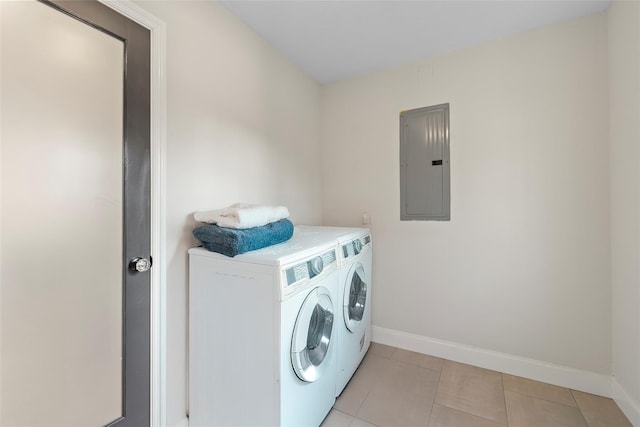 washroom featuring washer and dryer, light tile patterned floors, and electric panel