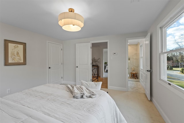 carpeted bedroom with multiple windows