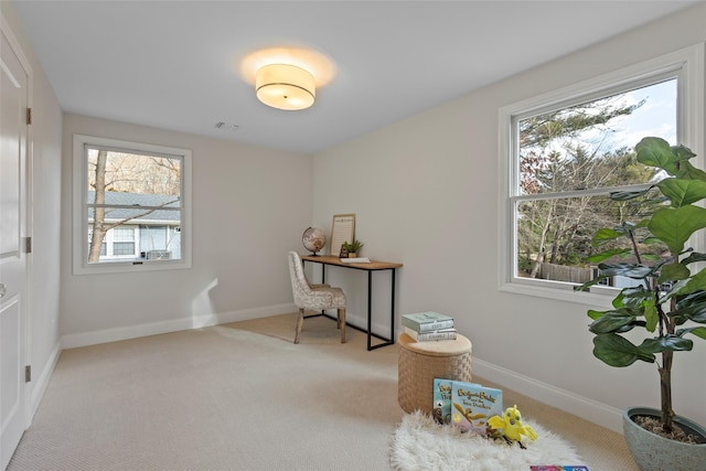 living area featuring light carpet and plenty of natural light