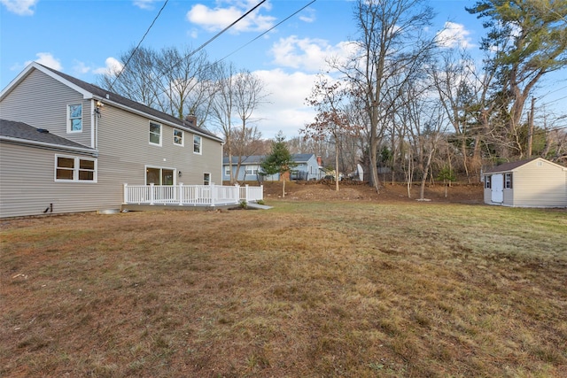 view of yard featuring a storage unit and a wooden deck