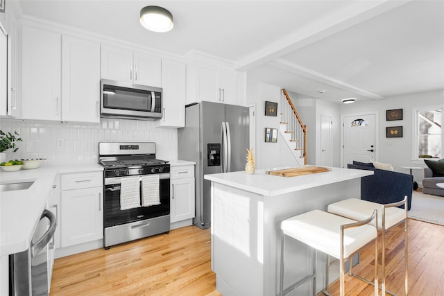 kitchen featuring white cabinetry, appliances with stainless steel finishes, and light hardwood / wood-style floors