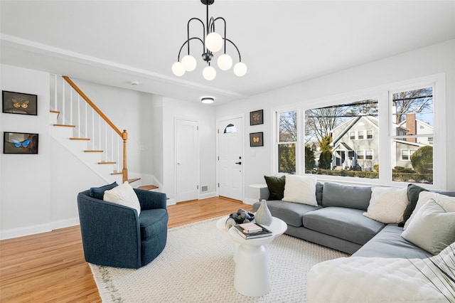 living room with wood-type flooring and an inviting chandelier