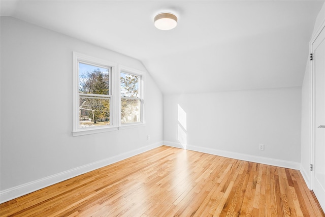 bonus room featuring lofted ceiling and light hardwood / wood-style flooring