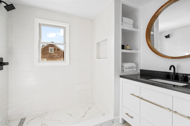 bathroom featuring vanity and a tile shower