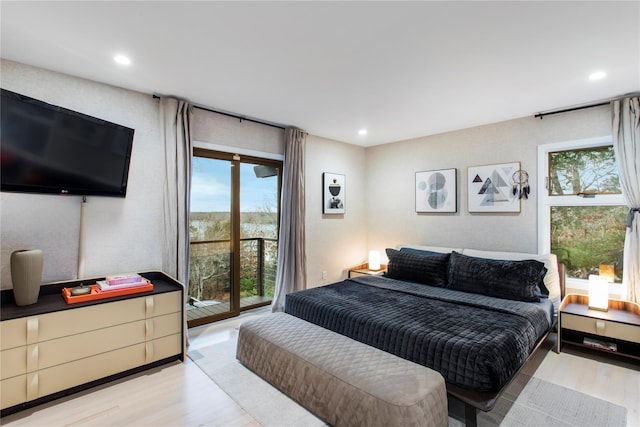 bedroom with light wood-type flooring, access to outside, and multiple windows