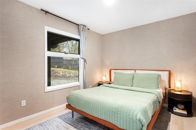 bedroom with hardwood / wood-style flooring