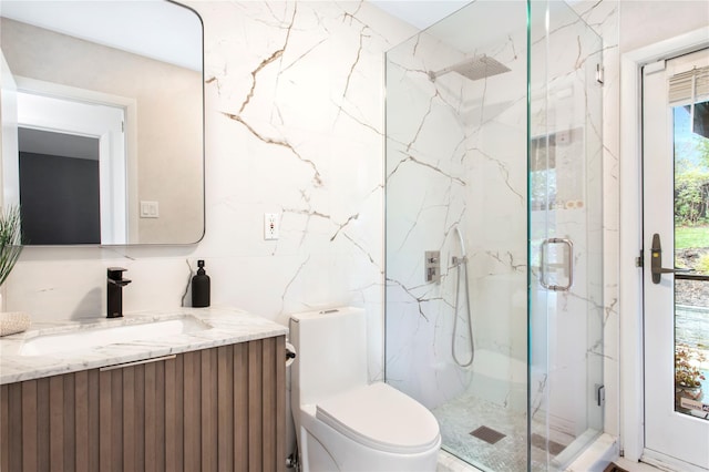 bathroom with vanity, toilet, a shower with shower door, and tasteful backsplash