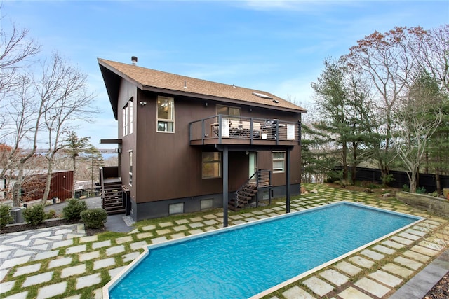 back of house featuring a balcony