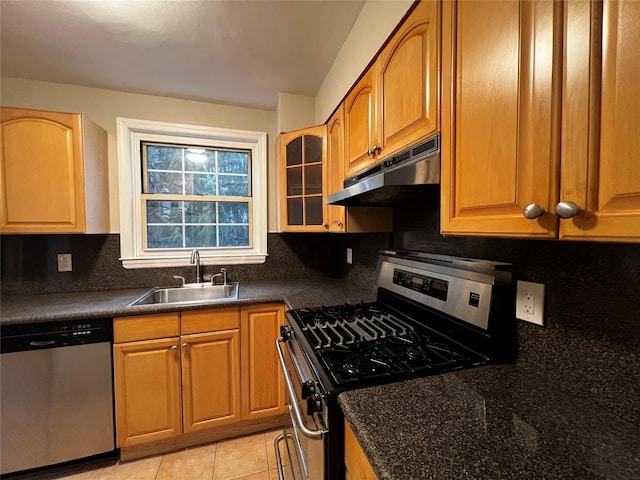 kitchen featuring decorative backsplash, sink, light tile patterned floors, and stainless steel appliances