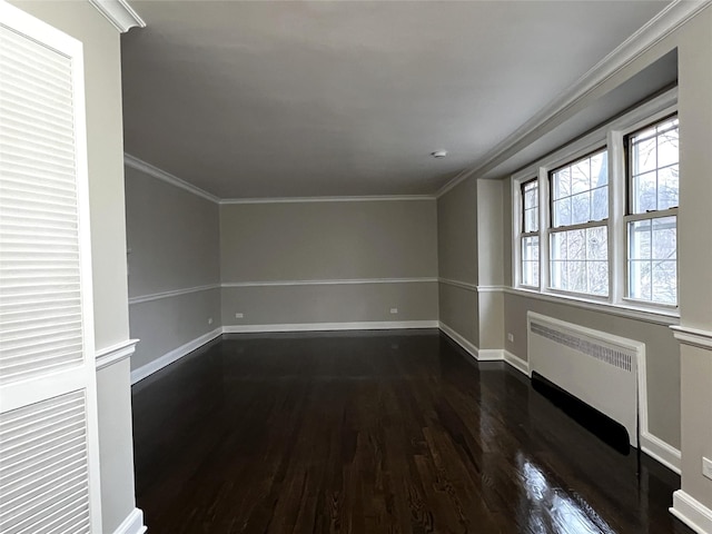 unfurnished room with radiator heating unit, dark wood-type flooring, and ornamental molding