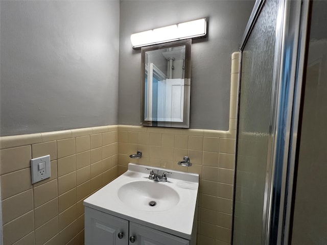 bathroom with vanity and tile walls