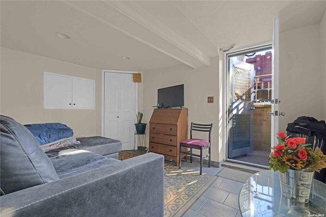 living room featuring beamed ceiling