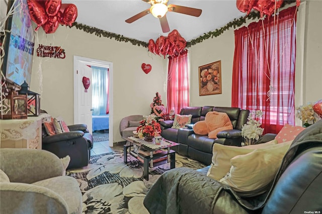 tiled living room with ceiling fan and a healthy amount of sunlight