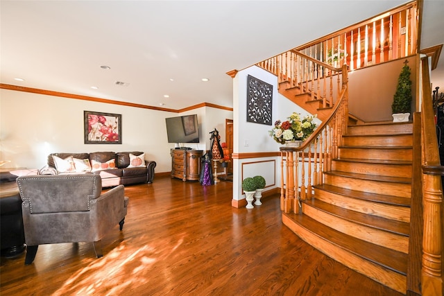 living room featuring hardwood / wood-style flooring and crown molding