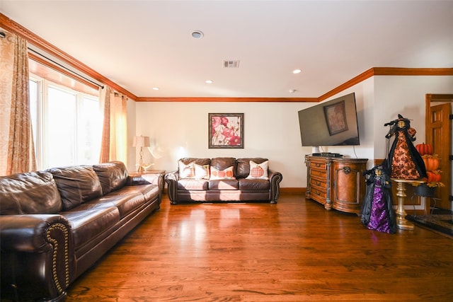 living room with wood-type flooring and ornamental molding