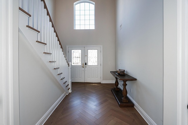 entryway with french doors, dark parquet flooring, and a wealth of natural light