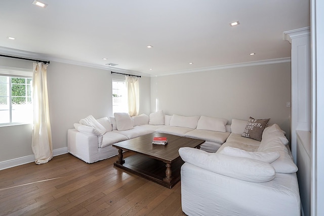 living room with crown molding, hardwood / wood-style floors, and a healthy amount of sunlight