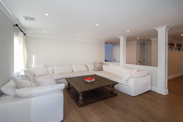 living room with decorative columns, wood-type flooring, and ornamental molding