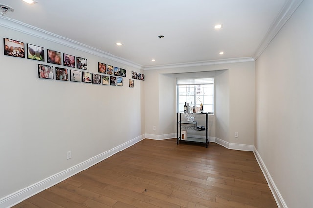 empty room featuring crown molding and dark hardwood / wood-style floors