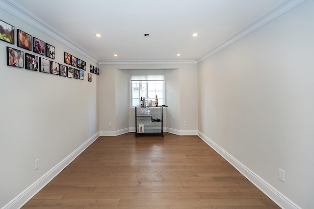 interior space featuring crown molding and hardwood / wood-style floors