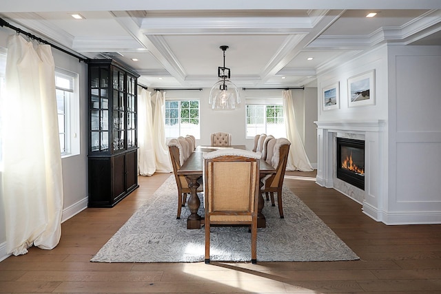 dining area featuring beamed ceiling, hardwood / wood-style floors, crown molding, and coffered ceiling