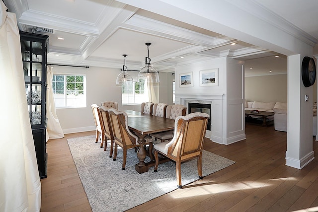 dining room with hardwood / wood-style floors, crown molding, beamed ceiling, and coffered ceiling