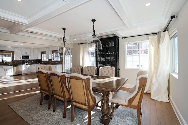 dining room featuring crown molding, plenty of natural light, and dark hardwood / wood-style floors