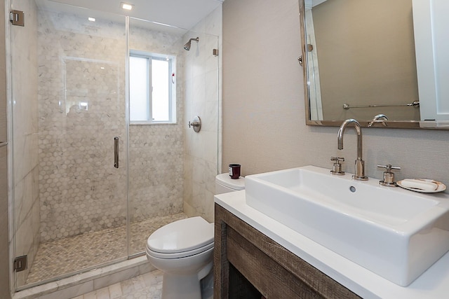 bathroom with vanity, toilet, and walk in shower