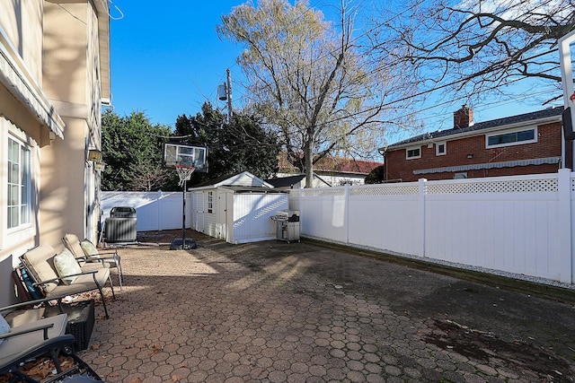 view of patio / terrace featuring a shed and central air condition unit