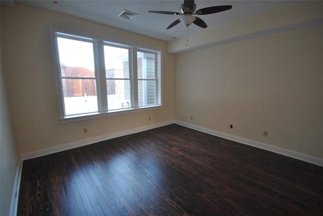 unfurnished room with dark hardwood / wood-style flooring and ceiling fan