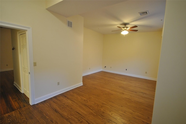 unfurnished room featuring ceiling fan and dark hardwood / wood-style flooring