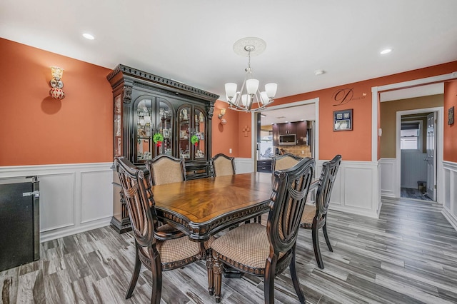 dining room with a chandelier and wood-type flooring